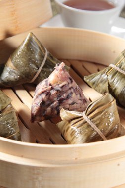 closeup of dim sum in  bamboo steamer 