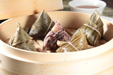 closeup of dim sum in  bamboo steamer 
