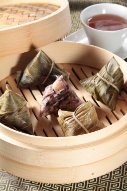 closeup of dim sum in  bamboo steamer 