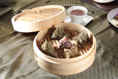closeup of dim sum in  bamboo steamer 