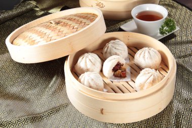 closeup of steamed buns bamboo steamer - dim sum