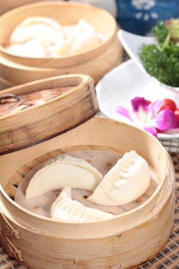 closeup of steamed buns bamboo steamer - dim sum