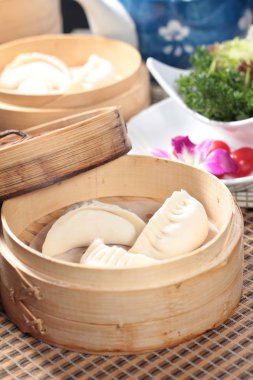closeup of steamed buns bamboo steamer - dim sum