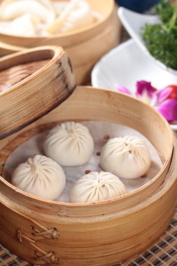 closeup of steamed buns bamboo steamer - dim sum