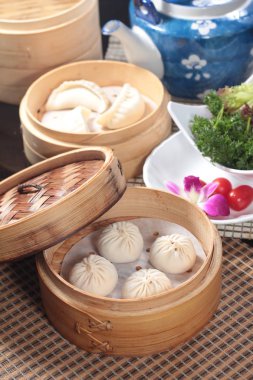 closeup of steamed buns bamboo steamer - dim sum