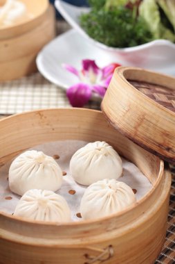 closeup of steamed buns bamboo steamer - dim sum