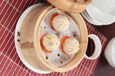 closeup of steamed dumplings in  bamboo steamer - dim sum