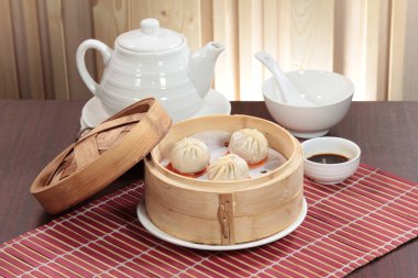 closeup of steamed dumplings in  bamboo steamer - dim sum