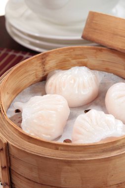closeup of steamed dumplings in  bamboo steamer - dim sum