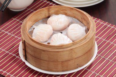 closeup of steamed dumplings in  bamboo steamer - dim sum