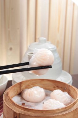 closeup of steamed dumplings in  bamboo steamer - dim sum