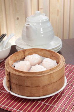 closeup of steamed dumplings in  bamboo steamer - dim sum