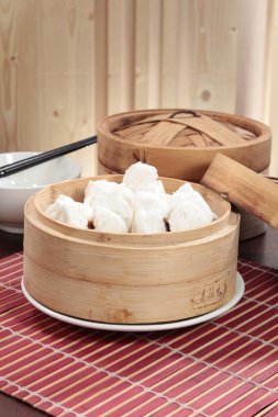 closeup of steamed dumplings in  bamboo steamer - dim sum