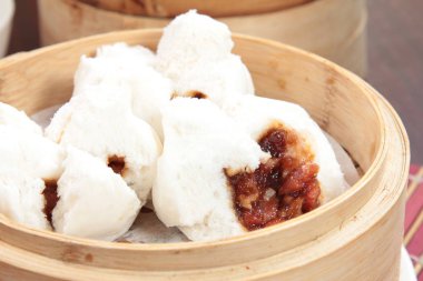 closeup of steamed dumplings in  bamboo steamer - dim sum