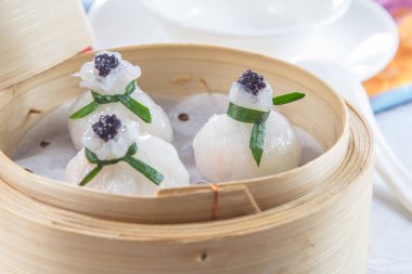 closeup of dim sum in  bamboo steamer 