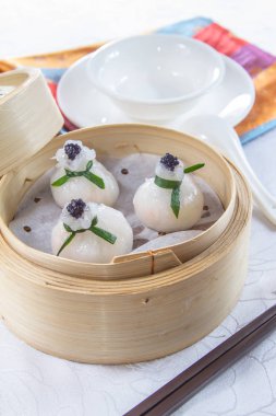 closeup of dim sum in  bamboo steamer 