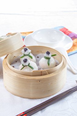 closeup of dim sum in  bamboo steamer 
