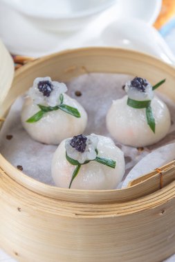 closeup of dim sum in  bamboo steamer 