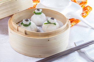 closeup of dim sum in  bamboo steamer 