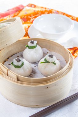 closeup of dim sum in  bamboo steamer 