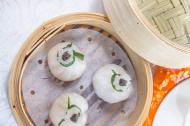 closeup of dim sum in  bamboo steamer 