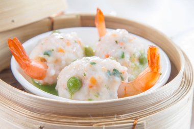 closeup of dim sum in  bamboo steamer 