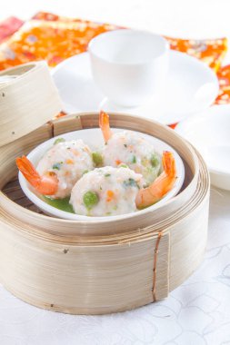 closeup of dim sum in  bamboo steamer 