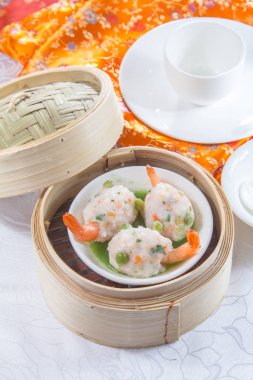 closeup of dim sum in  bamboo steamer 