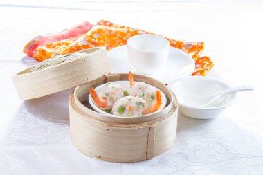 closeup of dim sum in  bamboo steamer 