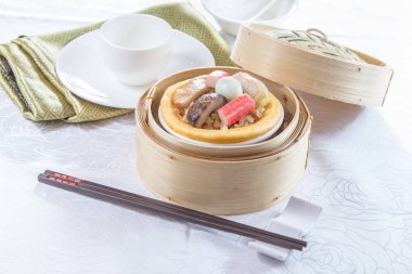 closeup of dim sum in  bamboo steamer 