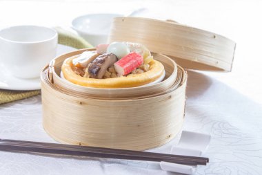 closeup of dim sum in  bamboo steamer 