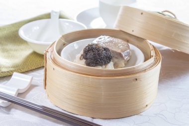 closeup of dim sum in  bamboo steamer 