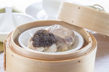 closeup of dim sum in  bamboo steamer 
