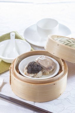 closeup of dim sum in  bamboo steamer 