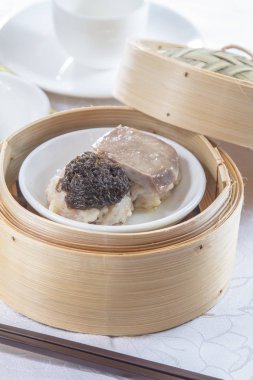 closeup of dim sum in  bamboo steamer 