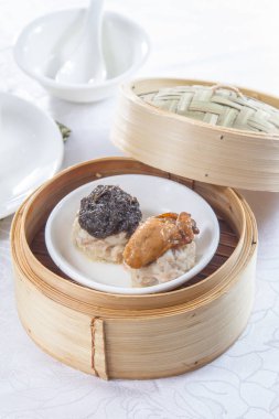 closeup of dim sum in  bamboo steamer 