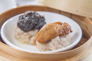 closeup of dim sum in  bamboo steamer 