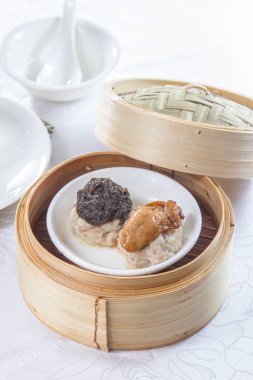closeup of dim sum in  bamboo steamer 