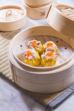 closeup of dim sum in  bamboo steamer 