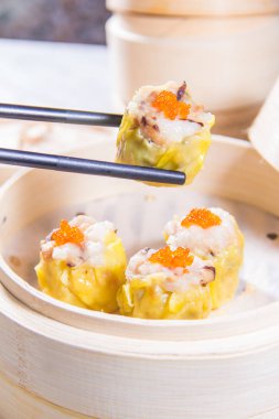 closeup of dim sum in  bamboo steamer 