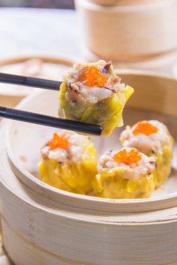 closeup of dim sum in  bamboo steamer 