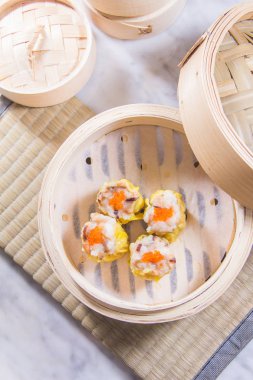 closeup of dim sum in  bamboo steamer 