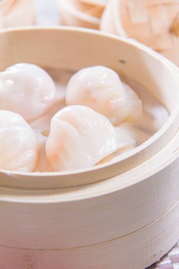 closeup of dim sum in  bamboo steamer 