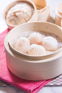 closeup of dim sum in  bamboo steamer 