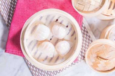 closeup of dim sum in  bamboo steamer 
