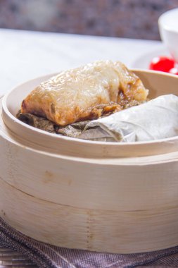 closeup of dim sum in  bamboo steamer 