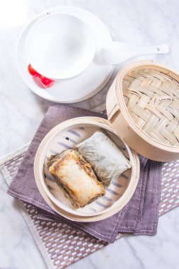 closeup of dim sum in  bamboo steamer 