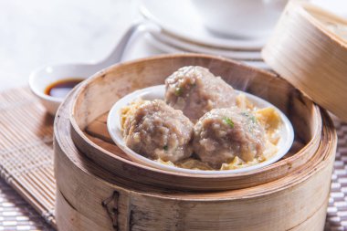 closeup of dim sum in  bamboo steamer 
