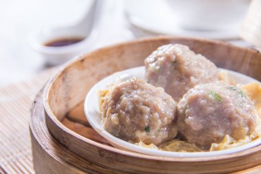 closeup of dim sum in  bamboo steamer 