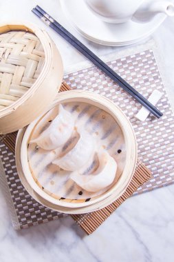 closeup of dim sum in  bamboo steamer 
